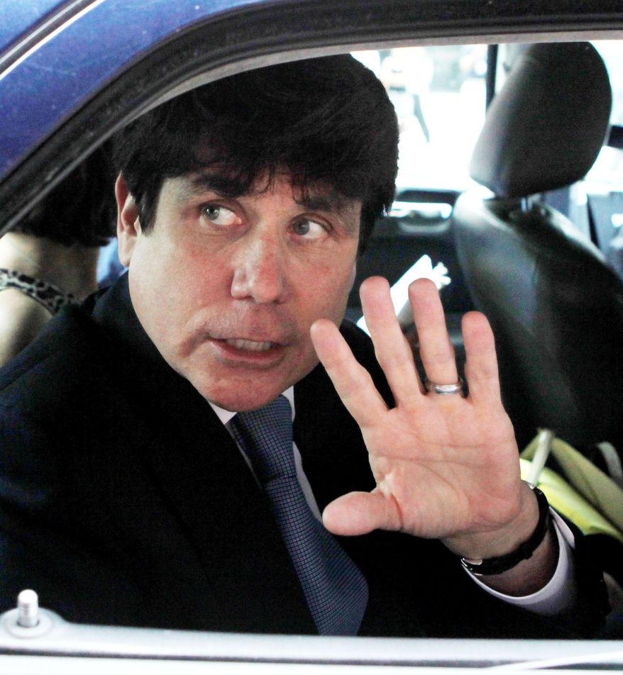 ASSOCIATED PRESS
Former Ilinois Gov. Rod R. Blagojevich acknowledges reporters and onlookers as he leaves the federal court building in Chicago after telling the judge in his corruption trial he will not testify.