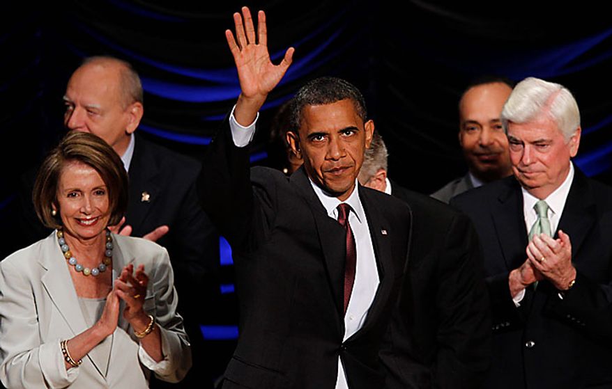 President Obama takes the stage before he signs the Dodd-Frank Wall Street Reform and Consumer Protection Act at the Ronald Reagan Building and International Trade Center in Washington on Wednesday, July 21, 2010. At right is Sen. Christopher J. Dodd, Connecticut Democrat, and House Speaker Nancy Pelosi, California Democrat, is at left. (AP Photo/Charles Dharapak)