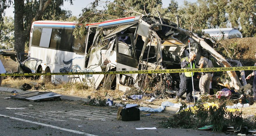 California Highway Patrol officers investigate the crash of a Greyhound bus on Highway 99 in Fresno, Calif., that killed at least six people and injured many others on Thursday, July 22, 2010. (AP Photo/Gary Kazanjian)