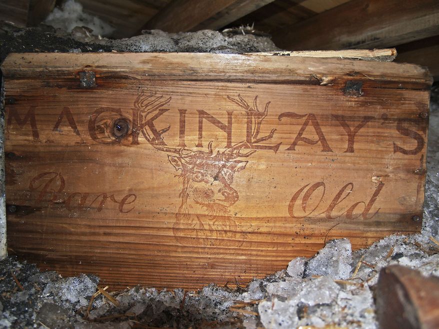 In this undated photo provided by Antarctic Heritage Trust via the Canterbury Museum, a whisky crate is stored beneath the floor of a hut built by British explorer Sir Ernest Shackleton during his 1908 Antarctic expedition. The crate of Scotch whisky that has been frozen in Antarctic ice for more than a century is being slowly thawed by New Zealand museum officials, for analysis, not to be tasted. (AP Photo/Antarctic Heritage Trust via the Canterbury Museum, Paul Terry)