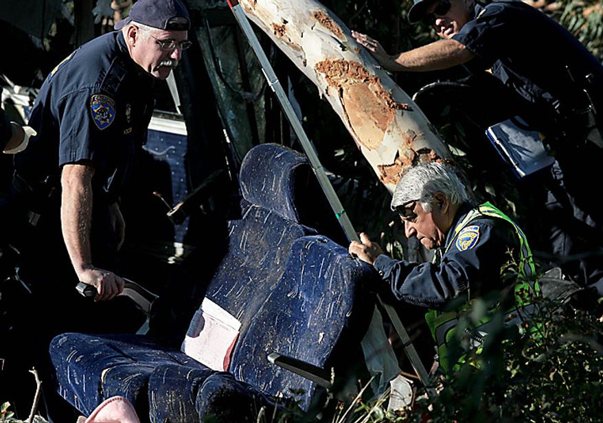 California Highway Patrol investigators look over seats from a fatal Greyhound bus accident in Fresno, Calif. on Thursday, July 22, 2010, in which at least six people were killed and others injured. (AP Photo/The Fresno Bee, John Walker)