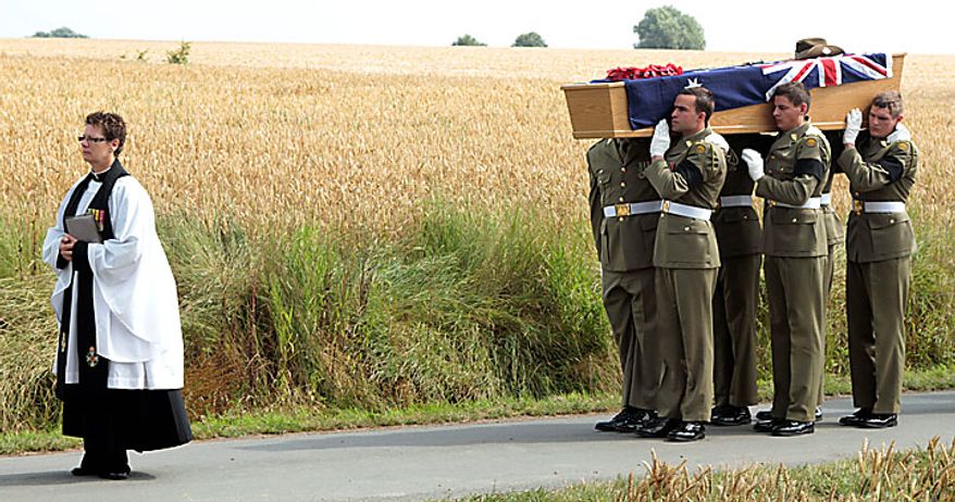 Members of the Australian Federation Guard carry the coffin of Australian WWI soldier, Private Alan James Mather, during a re-burial ceremony at Prowse Point Cemetery in Ploegsteert, Belgium on Thursday, July 22, 2010. The body of Mr. Mather was discovered by a British archeological team in 2008, and further DNA tests by a Belgian laboratory revealed his full identity. (AP Photo/Matthew Busch)