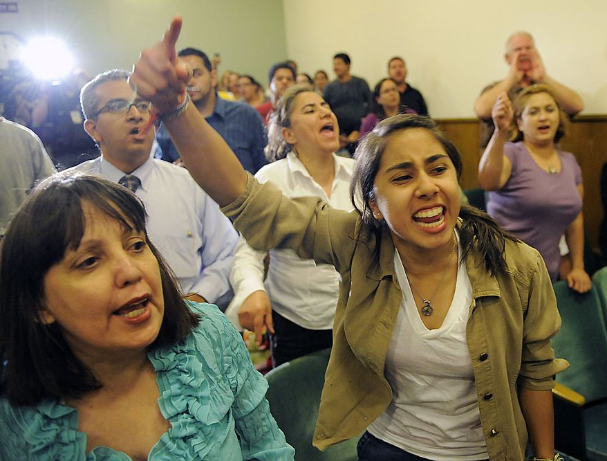 Local residents call for the ouster of Bell, Calif. city officials during a special city council meeting, Thursday, July 22, 2010, in Bell, Calif. Bell's police chief and two top city administrators agreed to resign Thursday night during a closed-door meeting at City Hall. Bell city leaders' pay has sparked anger in a blue-collar town that is one of the poorest in Los Angeles County. (AP Photo/Chris Pizzello)