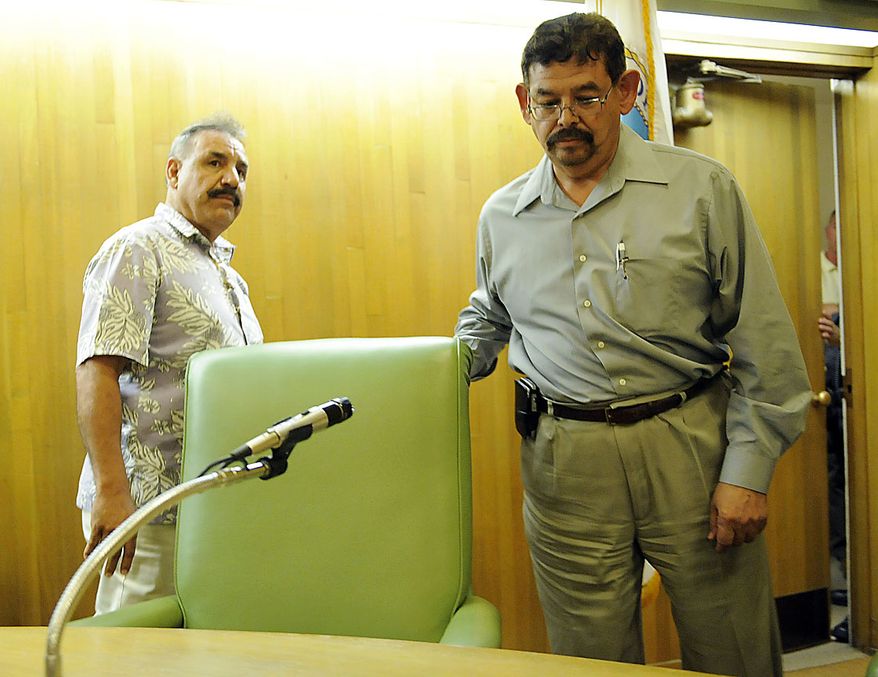 Oscar Hernandez, left, mayor of Bell, Calif., and city councillor George Mirabal prepare to exit a special city council meeting as residents call for their ouster, Thursday, July 22, 2010, in Bell, Calif. Council members emerged from an hours-long closed session at midnight Friday and announced that they'd accepted the resignations of Chief Administrative Officer Robert Rizzo, Assistant City Manager Angela Spaccia and Police Chief Randy Adams. Rizzo was the highest paid at $787,637 a year, nearly twice the pay of President Barack Obama, for overseeing one of the poorest towns in Los Angeles County. Spaccia makes $376,288 a year and Adams earns $457,000, 50 percent more than Los Angeles Police Chief Charlie Beck. (AP Photo/Chris Pizzello)