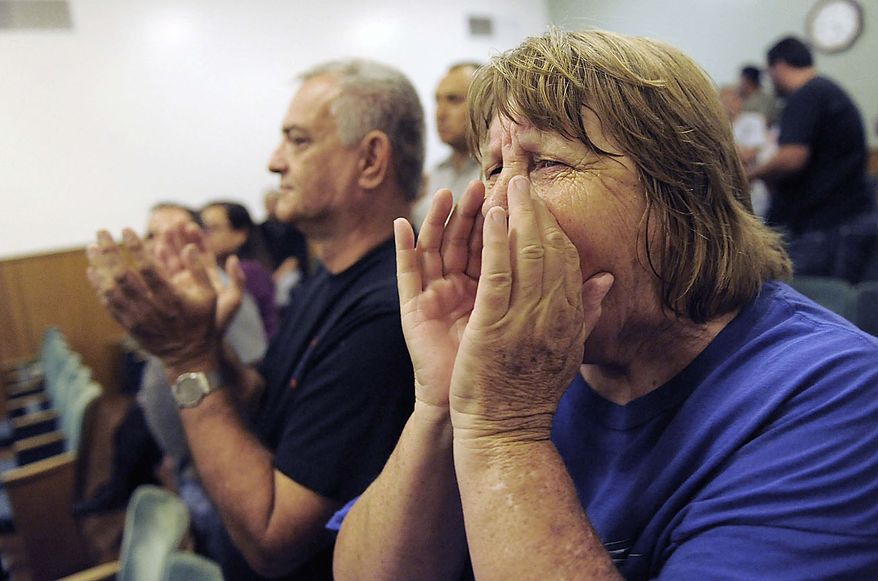Bell resident Donna Gannon shouts at city counselors during a special Bell city council meeting to consider firing the police chief and two top administrators, Thursday, July 22, 2010, in Bell, Calif. Revelations about Bell city leaders' pay has sparked anger in a blue-collar town that is one of the poorest in Los Angeles County. (AP Photo/Chris Pizzello)