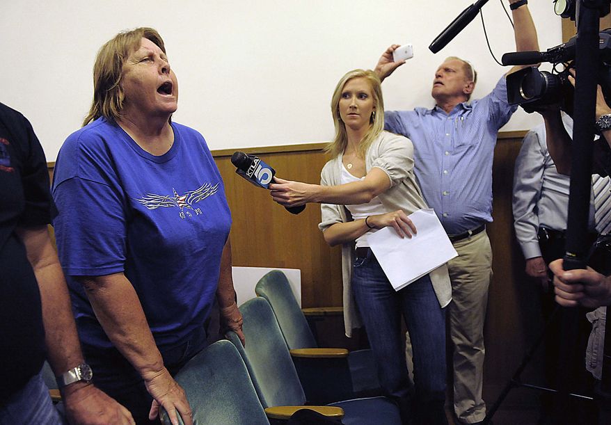 Bell resident Donna Gannon shouts at city counselors during a special meeting of the Bell City Council to consider the firing of the police chief and two top administrators in Bell, Calif., Thursday, July 22, 2010. Revelations about Bell city leaders' pay has sparked anger in a blue-collar town that is one of the poorest in Los Angeles County. (AP Photo/Chris Pizzello)