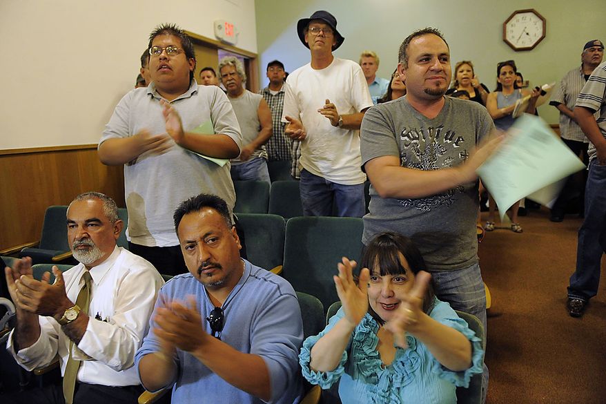 Bell city residents applaud a speaker during a special Bell City Council meeting to consider firing the police chief and two top administrators, Thursday, July 22, 2010, in Bell, Calif. Revelations about Bell city leaders' pay has sparked anger in a blue-collar town that is one of the poorest in Los Angeles County. (AP Photo/Chris Pizzello)