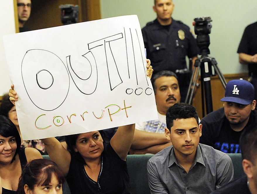 A resident of Bell, Calif,. holds up a placard calling for the ouster of city officials during a special city council meeting, Thursday, July 22, 2010, in Bell, Calif. Council members emerged from an hours-long closed session at midnight Friday and announced that they'd accepted the resignations of Chief Administrative Officer Robert Rizzo, Assistant City Manager Angela Spaccia and Police Chief Randy Adams. Rizzo was the highest paid at $787,637 a year, nearly twice the pay of President Barack Obama, for overseeing one of the poorest towns in Los Angeles County. Spaccia makes $376,288 a year and Adams earns $457,000, 50 percent more than Los Angeles Police Chief Charlie Beck. (AP Photo/Chris Pizzello)
