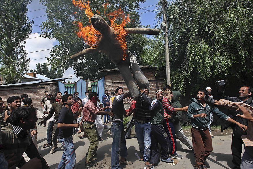 Kashmiri Muslim protesters burn an effigy of Jammu and Kashmir state Chief Minister Omar Abdullah during a protest in Srinagar, India, Friday, July 23, 2010. The predominantly Muslim region, where resistance to rule by Hindu-majority India is strong, has witnessed curfews and strikes for nearly a month after anti-India street protests and clashes surged. Residents accuse government forces of killing at least 17 people, mostly teenagers, in the demonstrations. (AP Photo/ Dar Yasin)