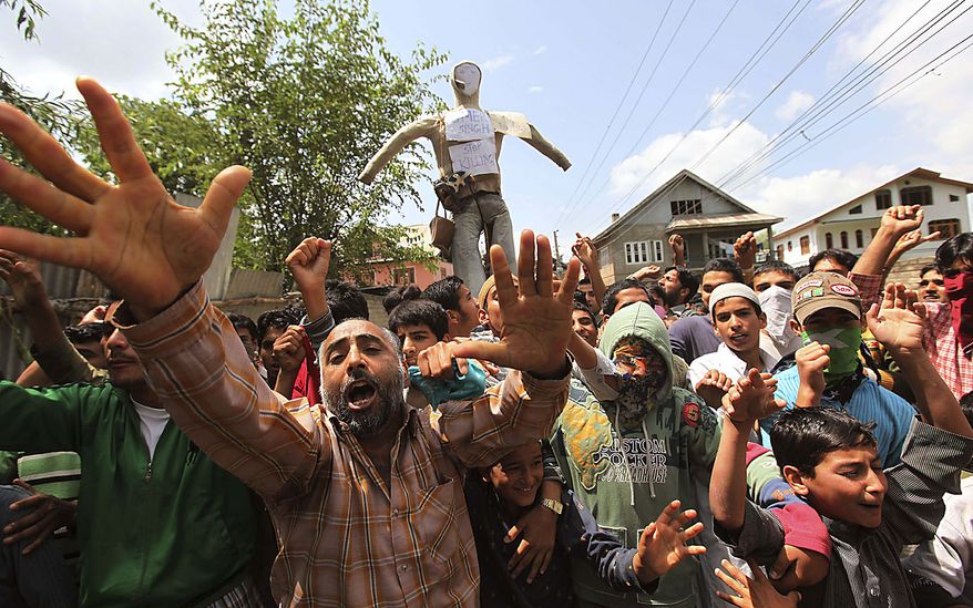 Kashmiri Muslim protesters shout pro-freedom slogans as they carry effigy of Jammu and Kashmir state Chief Minister Omar Abdullah during a protest in Srinagar, India, Friday, July 23, 2010. The predominantly Muslim region, where resistance to rule by Hindu-majority India is strong, has witnessed curfews and strikes for nearly a month after anti-India street protests and clashes surged. Residents accuse government forces of killing at least 17 people, mostly teenagers, in the demonstrations. (AP Photo/ Dar Yasin)