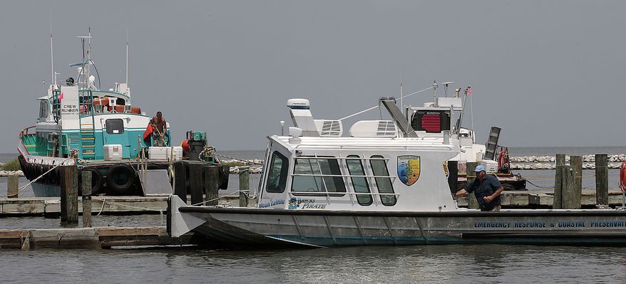 Work boats come to harbor in Grand Isle, La., Friday, July 23, 2010 in anticipation of Tropical Storm Bonnie making landfall sometime Saturday along the Louisiana coast. BP has recalled much of the oil skimming efforts in anticipation of bad weather. (AP Photo/Dave Martin)