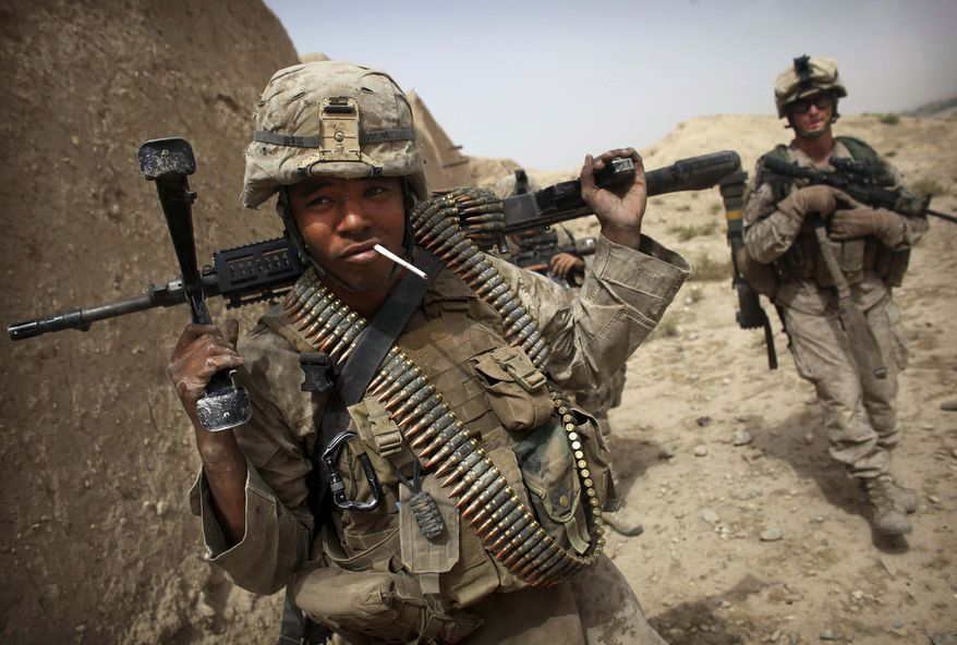 United States Marine LCpl. Brian Quinnones from Bravo Company of the 1st Battalion of the 2nd Marines has an unlit cigarette in his mouth following a gun battle as part of an operation to clear the area of insurgents near Musa Qaleh, in northern Helmand Province, southern Afghanistan, Friday, July 23, 2010. (AP Photo/Kevin Frayer)