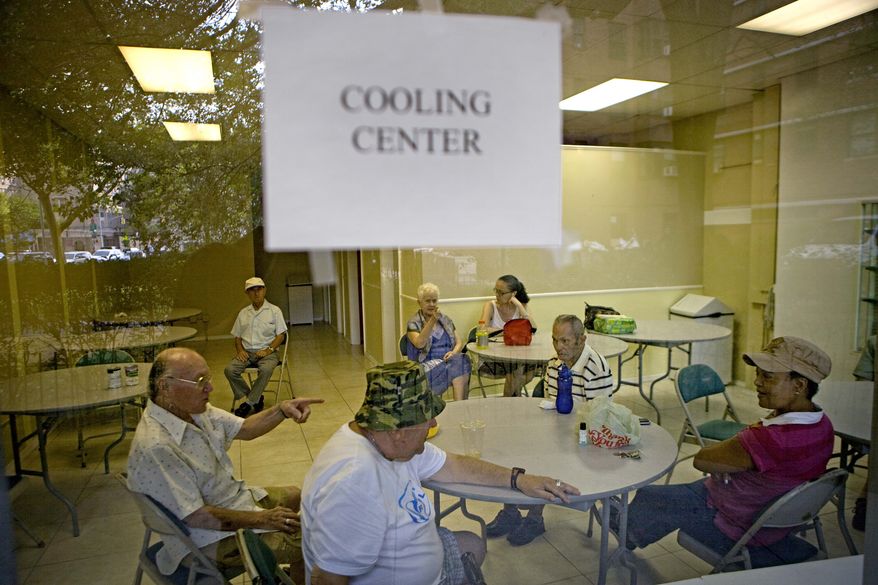 Residents of New York's Lower East Side neighborhood escape the heat in one of the city's designated cooling centers in New York, Saturday, July 24, 2010. More than 190,000 New Yorkers have visited cooling centers since the summer's first heat wave on June 28, the city said in a statement. (AP Photo/David Goldman)