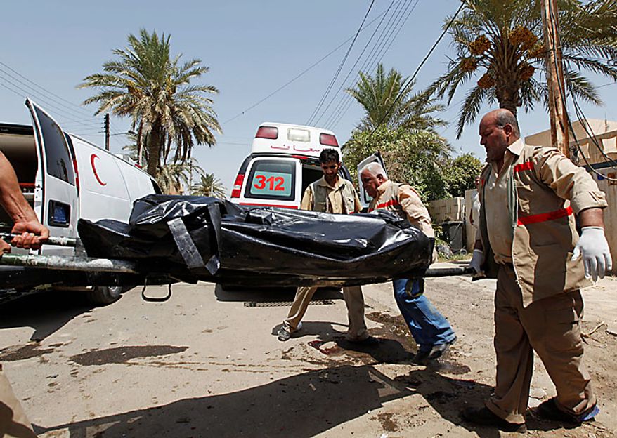 Paramedics carry a body on a stretcher outside the offices of the Al-Arabiya television station after a suicide bomber driving a minibus struck Baghdad, Iraq, Monday, July 26, 2010. The bomber was apparently waved through the first checkpoint at the Al-Arabiya television station after security guards checked his identification, said Iraqi military spokesman Maj. Gen. Qassim al-Moussawi. The blast killed and injured several people at the popular Arabic-language satellite news channel early Monday. (AP Photo/Hadi Mizban)