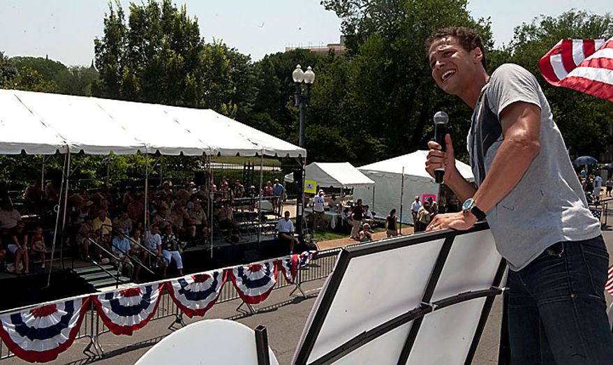 In this image provided by the Boy Scouts of America, singer/songwriter/actor Justin Guarini, a former Cub Scout, performs during the BSA Grand Centennial Parade, Sunday, July 25, 2010, in Washington. The Boy Scouts of America are celebrating 100 years of Scouting in the nation's capital as a kick-off to their National Jamboree being held at Fort AP Hill, Va., beginning July 26, 2010. (AP Photo/Boy Scouts of America, John Harrington)