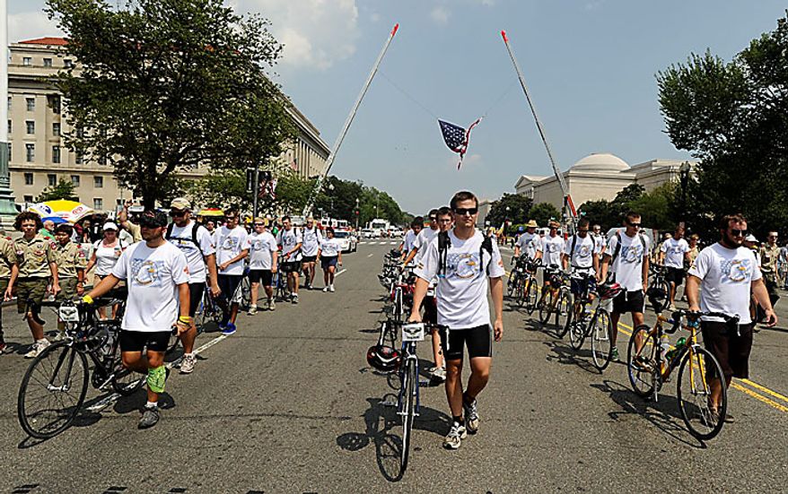 Fredericksburg's Troop 165 walk their bikes in the BSA Grand Centennial Parade after biking to Washington from Annapolis, Md. on Sunday, July 25, 2010. Members of the troop rode 2,000 thousand miles in 33 days in the Cycling the Loop for Scouting event. (AP Photo/The Free Lance-Star, Peter Cihelka)