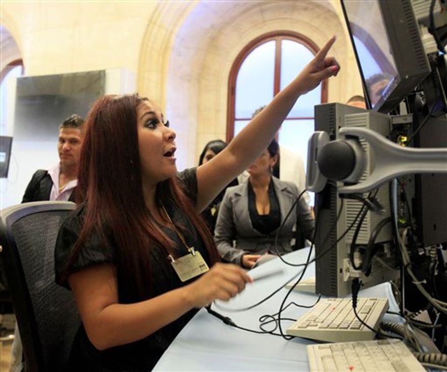 Nicole &quot;Snooki&quot; Polizzi, foreground, and cast members of MTV&#39;s &quot;Jersey Shore&quot; reality series pose for photos on the trading floor after participating in opening bell ceremonies of the New York Stock Exchange Tuesday, July 27, 2010. (AP Photo/Richard Drew)
