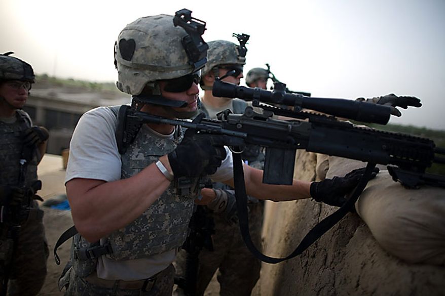 US Army soldiers of the 1-320th Alpha Battery, 2nd Brigade of the 101st Airborne Division, over-watch insurgent positions during clashes at COP Nolen, in the volatile Arghandab Valley, Kandahar, Afghanistan, Tuesday, July 27, 2010. (AP Photo/Rodrigo Abd)