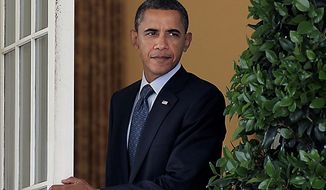 President Barack Obama steps out of the Oval Office of the White House in Washington, Tuesday, July 27, 2010, to make an appeal for bipartisanship on his legislative agenda, in the Rose Garden. (AP Photo/J. Scott Applewhite) 