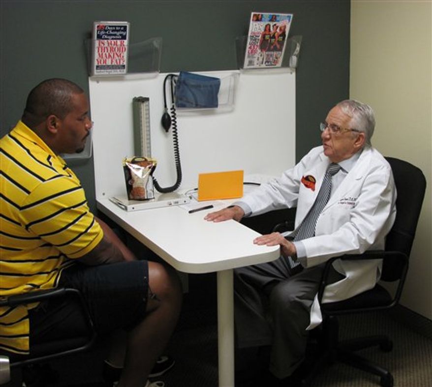 In this photo released by 5W Public Relations and taken on June 11, 2010, New York Jets' Kris Jenkins, left, speaks with Dr. Sanford Siegal in Miami. Jenkins, the New York Jets' hefty nose tackle, tells The Associated Press he has lost about 20 pounds since starting the popular Dr. Siegal's Cookie Diet in May. (AP Photo/5W Public Relations)