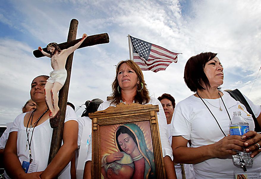 From left, Maria Duran, Maria Uribe and Giornia Sanchez march in protest Thursday, July 29, 2010 in Phoenix to rally against Arizona's new immigration law, SB1070. Opponents of Arizona's immigration crackdown went ahead with protests Thursday despite a judge's ruling that delayed enforcement of most the law. (AP Photo/Matt York)