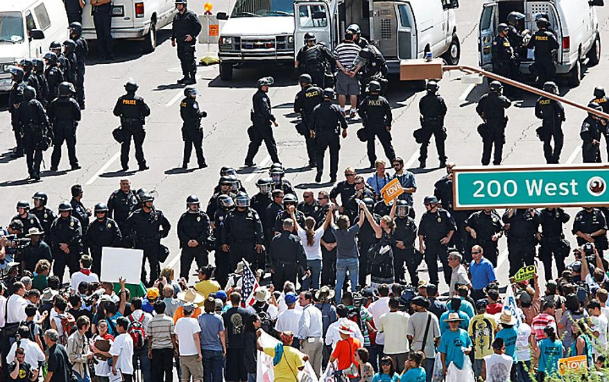 Phoenix Police make arrests of people protesting the SB1070 law in front of the office of the Maricopa County Sheriff on Washigton Street in downtown Phoenix, Thursday, July 29, 2010. Federal Judge Susan Bolton struck down parts of the legislation yesterday. (AP Photo/The Arizona Republic, Rob Schumacher)