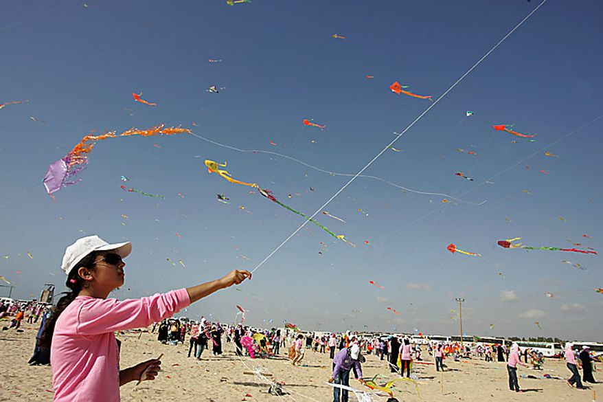 Thousands of Palestinian children fly kites along the beach during a U.N.-sponsored summer camp in the northern Gaza Strip on Thursday, July 29, 2010. The children claimed a world record, flying thousands of kites at the same time. About 8,000 children attended in the event, Khalil el-Halabi, education program head at the U.N. Relief and Works Agency, said. (UPI/Ismael Mohamad)