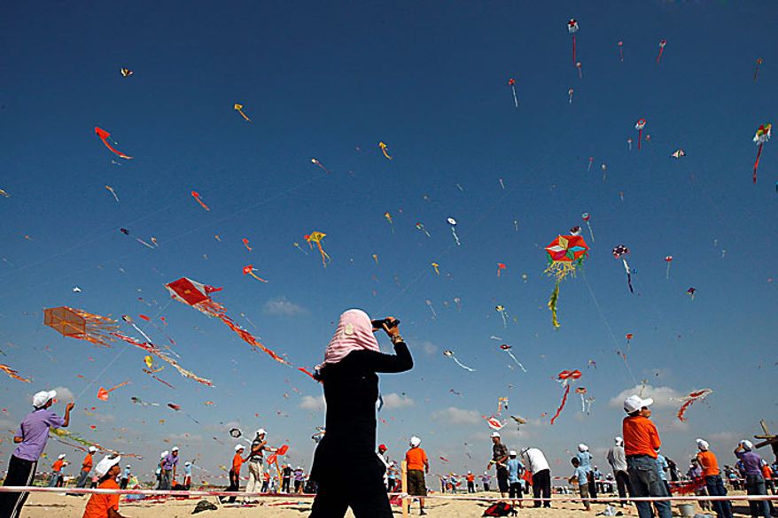 Thousands of Palestinian children in Beit Lahiya, Gaza Strip, fly kites in an attempt to break the world record for the number of kites flying simultaneously. More than 7,200 kites were raised into the air on Thursday, July 29, 2010, setting a new world record in an event sponsored by the United Nations. (AP Photo/Khalil Hamra)