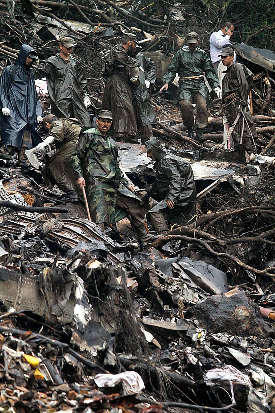 Pakistani army troops search on Thursday, July 29, 2010, for evidence and victims of Wednesday's deadly plane crash in the mountains surrounding Islamabad, Pakistan. The Airbus A321 operated by Pakistani carrier Airblue crashed into hills overlooking the country's capital, Islamabad, during stormy monsoon weather, killing all 152 people on board. (AP Photo/Anjum Naveed)