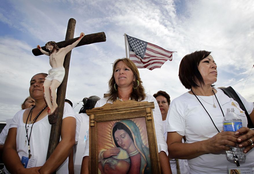 From left, Maria Duran, Maria Uribe and Giornia Sanchez march in protest Thursday, July 29, 2010, in Phoenix to rally against Arizona's new immigration law, SB1070. Opponents of Arizona's immigration crackdown went ahead with protests Thursday despite a judge's ruling that delayed enforcement of most the law. (AP Photo/Matt York)