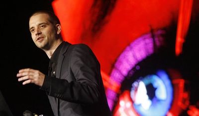 In this July 30, 2010 photo, hacker Chris Paget sets up a long range RFID reading device at the DefCon hacker conference in Las Vegas. (AP Photo/Isaac Brekken)