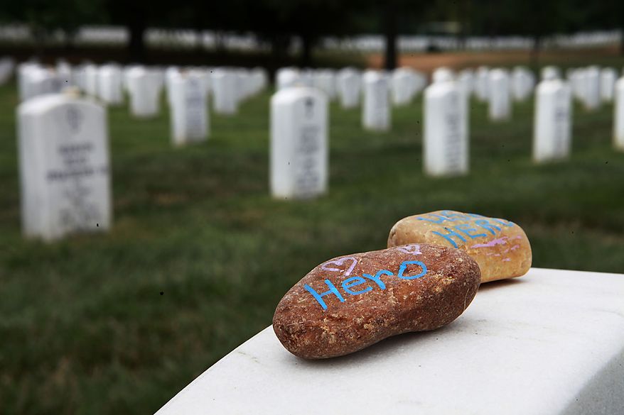 Stones with the word "hero" written on them lay on a grave stone in Section 60, where many soldiers from the Iraq and Afghanistan wars are buried, Thursday, July 29, 2010, at Arlington National Cemetery in Arlington, Va. Estimates of the number of graves that might be affected by mix-ups at Arlington National Cemetery grew from hundreds to as many as 6,600 on Thursday, as the cemetery's former superintendent blamed his staff and a lack of resources for the scandal that forced his ouster. (AP Photo/Jacquelyn Martin)