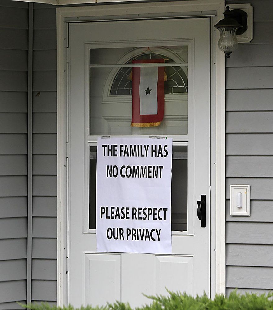 A sign asking for privacy is posted on the front door of the home of Petty Officer 3rd Class Jarod Newlove, Thursday, July 29, 2010, in Seattle. According to a senior U.S. military official and Afghan officials, Newlove, the second U.S. Navy sailor who went missing in a dangerous part of eastern Afghanistan was found dead and his body recovered. The family of Newlove, 25, had been notified of his death, the U.S. military official said on the condition of anonymity, because he was not authorized to disclose the information. (AP Photo/Elaine Thompson)