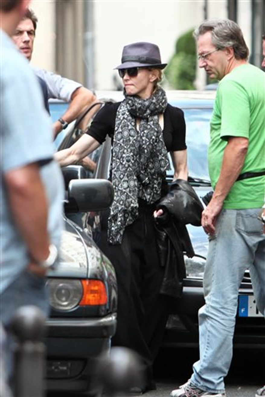 U.S performer Madonna, centre, during the filming of the movie "W.E", which she is directing, in Paris, Saturday July 31, 2010. (AP Photo/Thibault Camus)