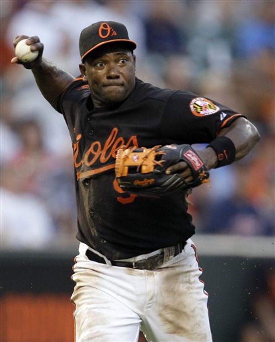 FILE - In this July 23, 2010 file photo, Baltimore Orioles third baseman Miguel Tejada throws during a baseball game against the Minnesota Twins in Baltimore. A person familiar with the deal says the NL West-leading San Diego Padres have traded for Baltimore infielder Miguel Tejada. The person spoke to The Associated Press on condition of anonymity because neither club had made an announcement Thursday, July 29, 2010. (AP Photo/Rob Carr, File)
