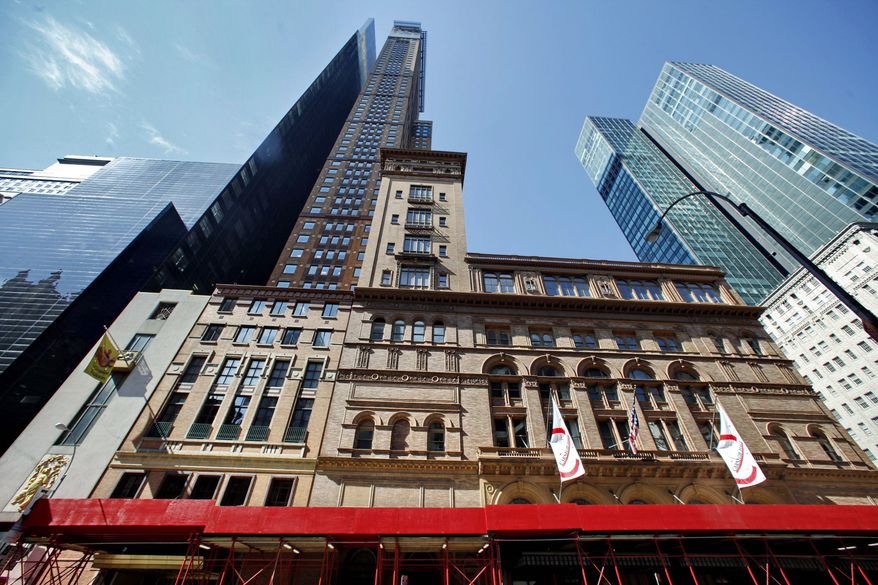 Scaffolding rings Carnegie Hall in New York as the century-old red brick towers that once occupied by Marlon Brando and Leonard Bernstein are turned into new rehearsal space and offices. Residents lost a bitter years-long battle to save the studios that philanthropist Andrew Carnegie created for active artists. (Associated Press)