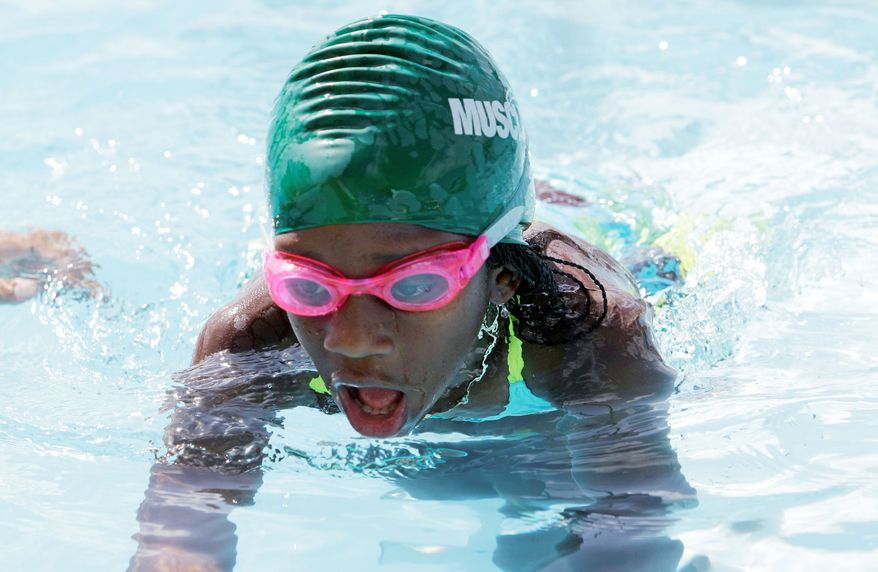 Maggie Berry, 9, practices at Swim Gym in Key Biscayne. Maggie is one of the students learning how to swim as part of an outreach program. (Associated Press)