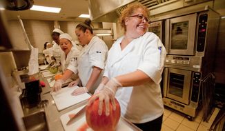 ** In this 2010 file photo, Denver public schools&#39; food-service employees participate in a competition at the Bruce Randolph School. (Associated Press)