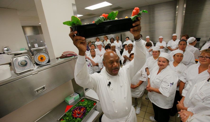 Chef Daniel Young chooses the winning fruit salad tray made by Denver public schools food-service personnel during a half day of instruction on how to use fresh foods to make healthier options for students. (Associated Press)