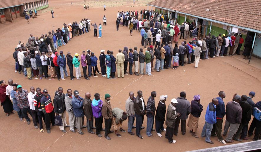 Kenyans wait to cast their votes during the referendum for Kenya&#39;s new constitution in Nairobi on Wednesday. Lines formed before sunrise to vote on a measure that would reduce the powers of the president and give citizens a bill of rights. (Associated Press)