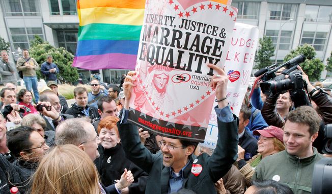 VICTORY PARTY: In San Francisco on Wednesday, Stuart Gaffney holds up a sign while celebrating a court&#x27;s decision to overturn Proposition 8. (Associated Press)