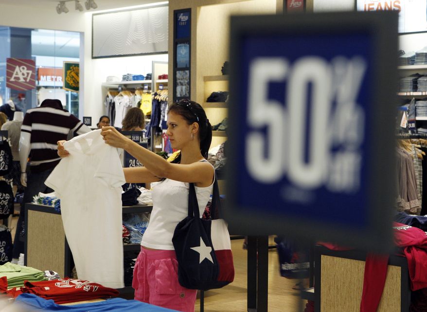 A customer shops in late July at an Aeropostale store in Paramus, N.J., where some items are marked down 50 percent. (AP Photo/Mel Evans)