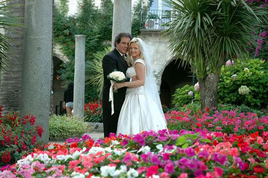 In this July 2005 photo provided by Lynn France, Lynn France, right, poses for a photo with her husband John France on their wedding day on Italy's Amalfi Coast. In January of 2009, France discovered her husband's second wedding on Facebook. (AP Photo/Courtesy of Lynn France)