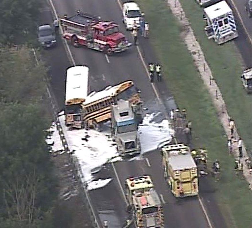 This image made from video provided by KTVI shows responders at the scene of an accident involving two school buses, a pickup truck and a tractor-trailer rig on Thursday, Aug. 5, 2010, on eastbound Interstate 44 near Gray Summit, Mo. A girl on one of the buses and the driver of the pickup were killed. (AP Photo/KTVI)