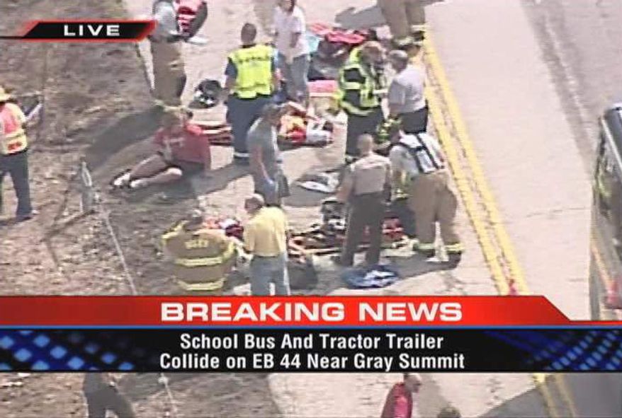 This image made from video provided by KTVI shows responders at the scene of an accident involving two school buses, a pickup truck and a tractor-trailer rig on Thursday, Aug. 5, 2010, on eastbound Interstate 44 near Gray Summit, Mo. A girl on one of the buses and the driver of the pickup were killed. (AP Photo/KTVI)