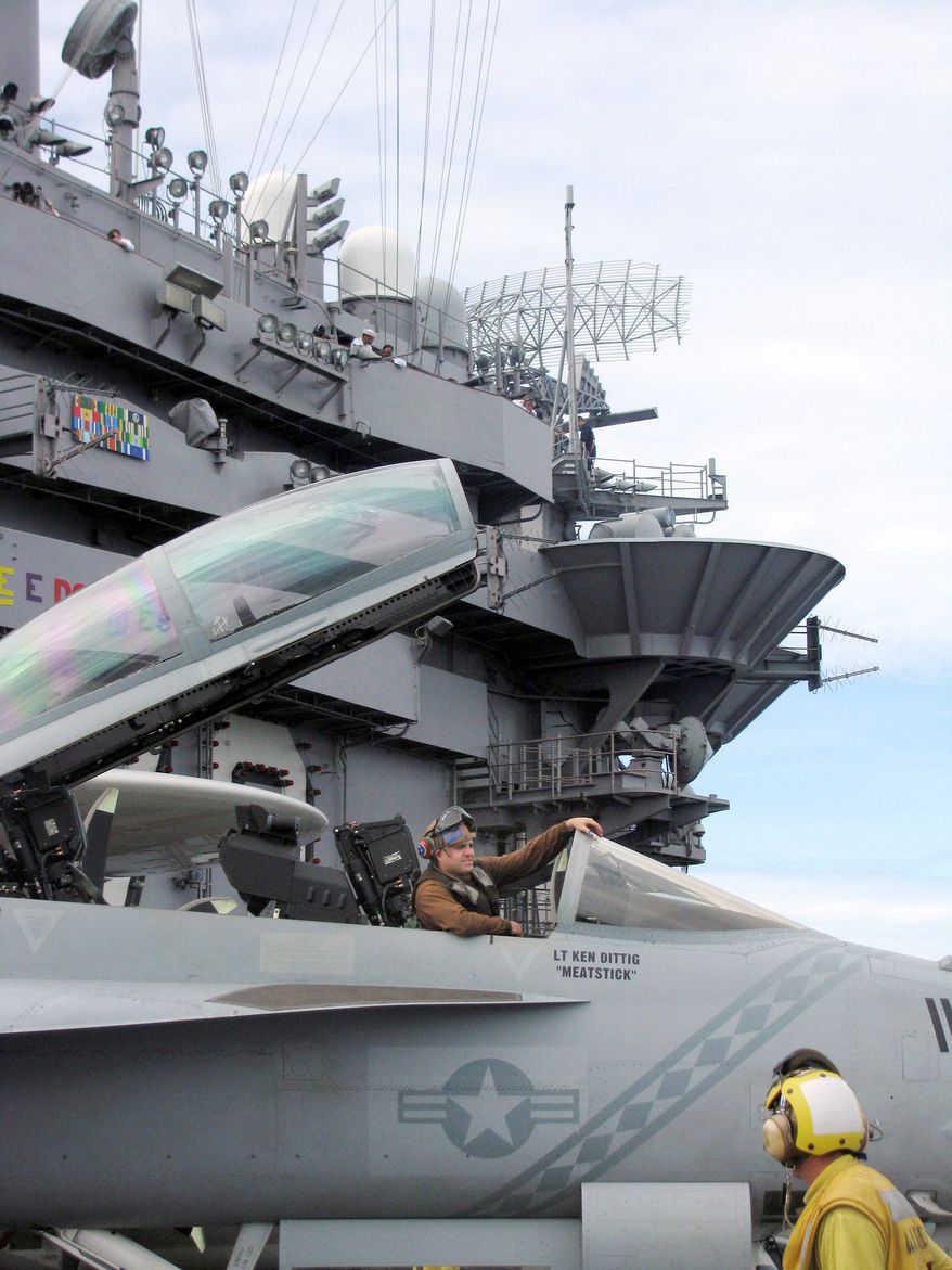 Associated Press
Crew members of the USS George Washington park an F/A-18. The Pacific balance of power may shift soon with China's development of a 'game-changing' weapon.