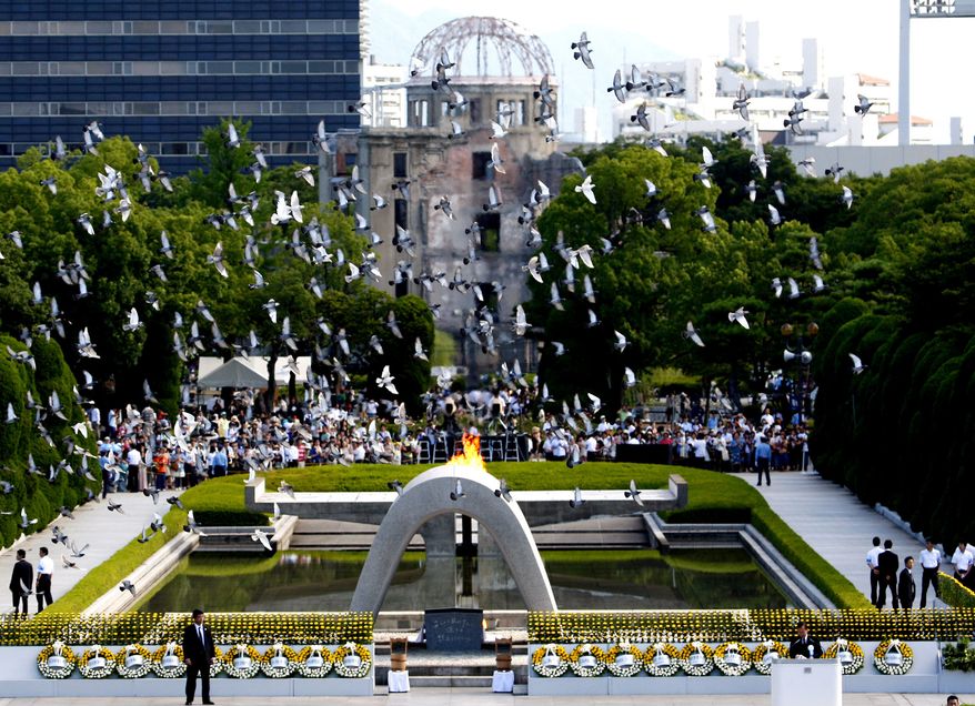 With the gutted Atomic Bomb Dome as a backdrop, doves fly over the cenotaph of the Peace Memorial Park at Hiroshima, western Japan, Friday, Aug. 6, 2010. Hiroshima marked the 65th anniversary of the the world's first atomic bomb attack that devastated the western Japanese city at the closing days of World War II. (AP Photo/Shuji Kajiyama)