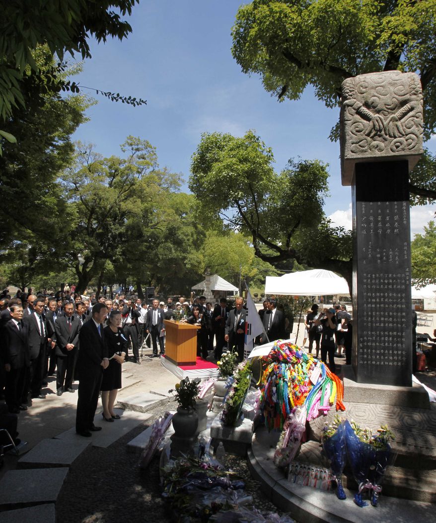 U.N. Secretary-General Ban Ki-moon, left front, and his wife Yoo Soon-taek pray at the cenotaph for Korean atomic bomb victims at the Peace Memorial Park at Hiroshima, western Japan, Friday, Aug. 6, 2010. Hiroshima marked the 65th anniversary of the the world's first atomic bomb attack that devastated the western Japanese city at the closing days of World War II. (AP Photo/Shuji Kajiyama)