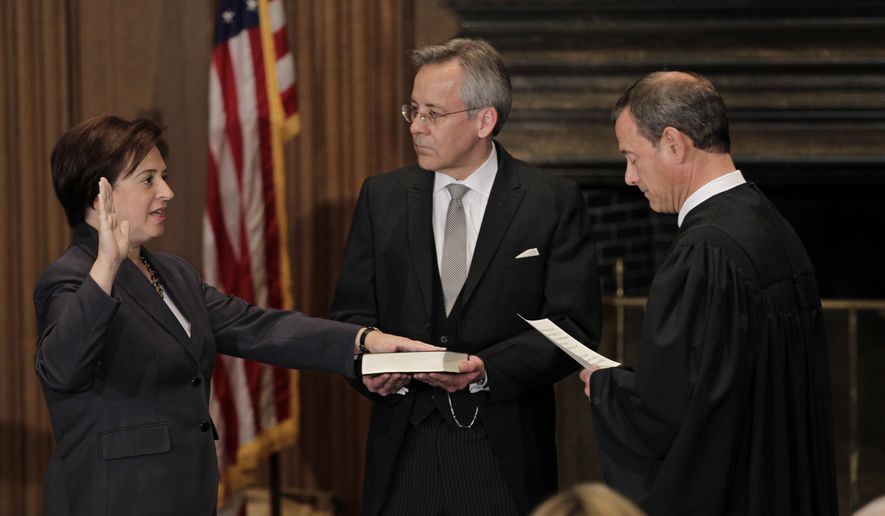 Elena Kagan is sworn in as the Supreme Court&#x27;s newest member as Chief Justice John Roberts, right, administers the judicial oath, at the Supreme Court Building in Washington, Saturday, Aug. 7, 2010. The Bible is held by Jeffrey Minear, center, counselor to the chief justice. Kagan, 50, who replaces retired Justice John Paul Stevens, becomes the fourth woman to sit on the high court, and is the first Supreme Court justice in nearly four decades with no previous experience as a judge. (AP Photo/J. Scott Applewhite)