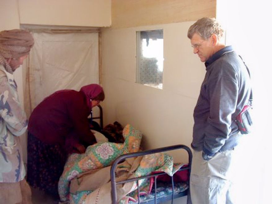 In this undated photo released by David L. Evans, Tom Little, right, optometrist and team leader with the International Assistance Mission, watches as an unidentified doctor examines a patient in an Afghanistan clinic. Members of a medical team, including Tom Little, were shot and killed by militants as they were returning from providing eye treatment and other health care in remote villages in northern Afghanistan, a spokesman for the team said Saturday, Aug. 7, 2010. Tom Little, an optometrist from Delmar, New York, has been working in Afghanistan for more than 30 years, according to Dirk Frans, director of the International Assistance Mission. (AP Photo/Provided by David L. Evans)